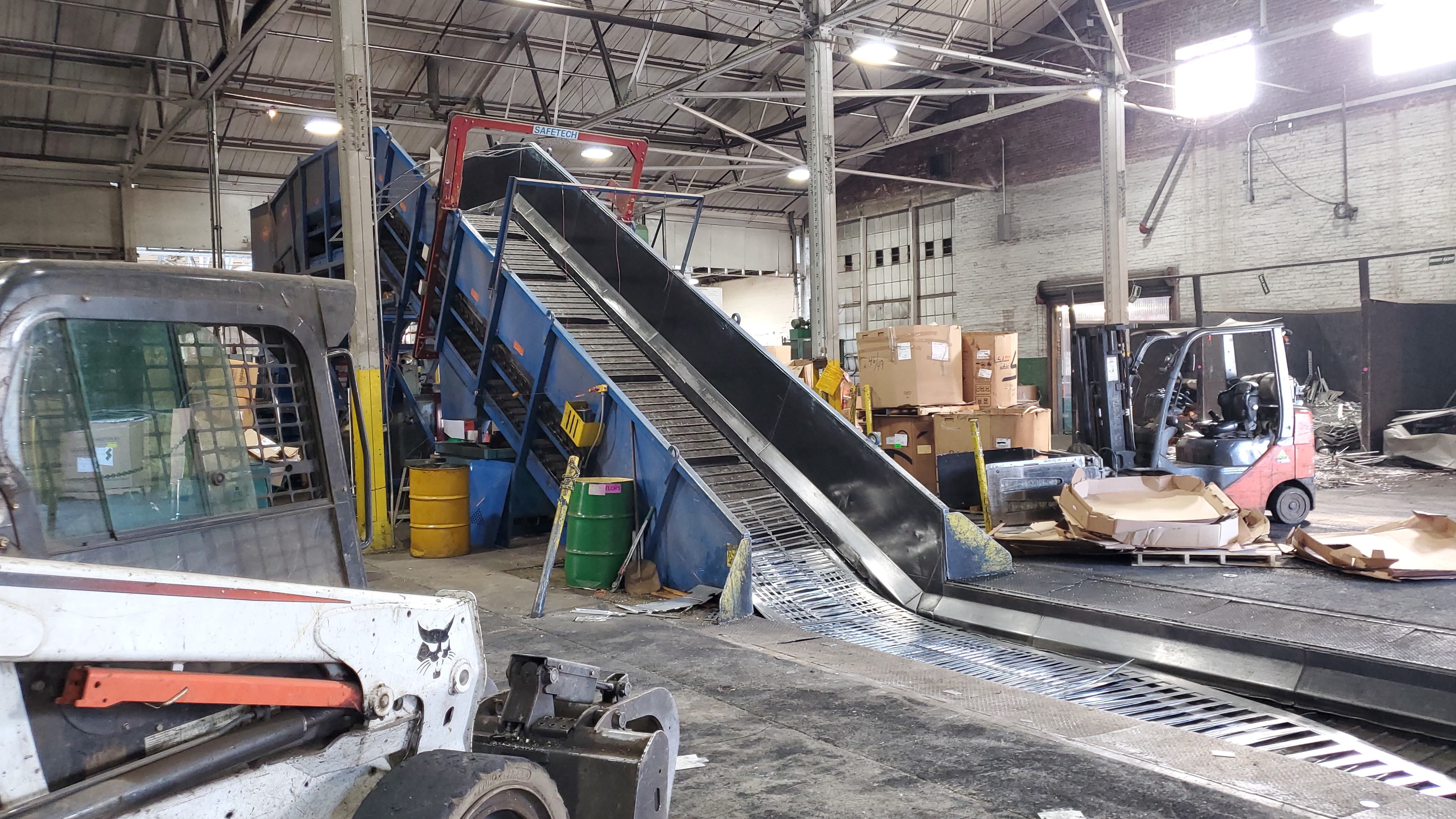 Large conveyor and baler line equipment in a recycling facility